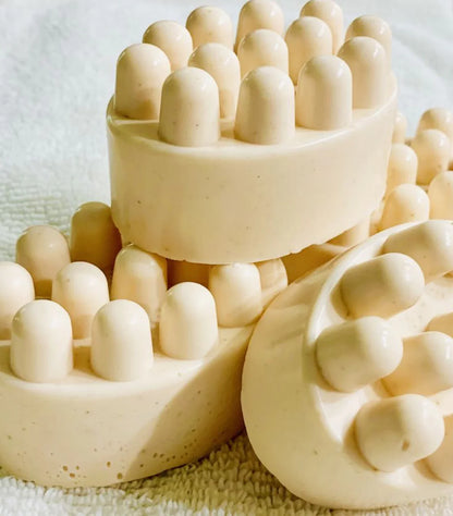 Oatmeal and goat's milk soap by shovota, showcasing a creamy bar with a textured surface, ideal for sensitive skin.
